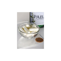 Miniatura de Uma taça de Swanson PABA - 500 mg 120 cápsulas ao lado de uma garrafa de vinho, promovendo a saúde da pele através dos seus processos antioxidantes e ajudando na formação de glóbulos vermelhos.