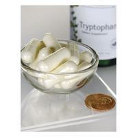 Thumbnail for A small glass bowl of white capsules sits next to a penny for scale, with a Swanson L-Tryptophan 500 mg 60 Capsules bottle in the background. This essential amino acid is noted for promoting restful sleep.