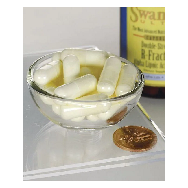 A glass bowl of white capsules is next to a larger Swanson pill bottle, labeled "R-Fraction Alpha Lipoic Acid 100 mg 60 Capsules," suggesting cardiovascular health benefits. A penny provides size reference.