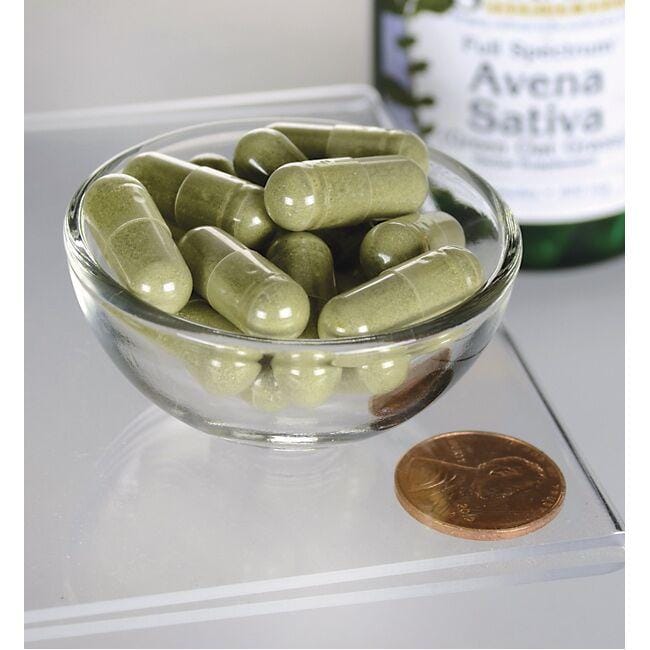 Uma taça de Swanson Avena Sativa - 400 mg 60 capsules ao lado de uma garrafa de azeite.