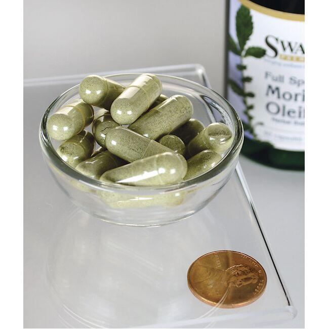 Swansons Moringa Oleifera - 400 mg 60 capsules numa taça ao lado de um frasco de Swanson's Moringa Oleifera, realçando os benefícios da redução do stress oxidativo e dos danos celulares.