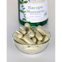 Miniatura do suplemento alimentar Bacopa Monnieri da Swanson- 50 mg 90 cápsulas numa taça ao lado de um frasco.