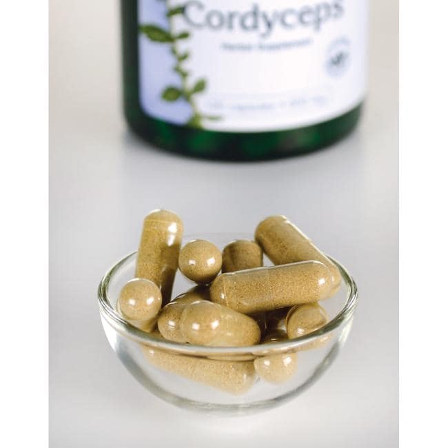 Swanson Cordyceps - 600 mg 120 cápsulas numa taça ao lado de um frasco de Swanson Cordyceps.