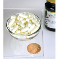 Thumbnail para Uma taça de Swanson Melatonin 3 mg 60 capsules ao lado de uma moeda.