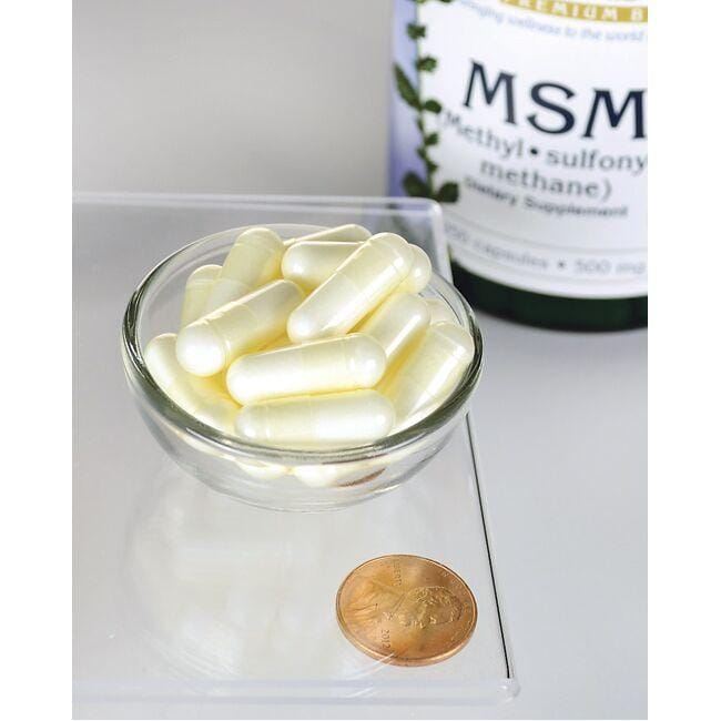 Swanson MSM - 500 mg 250 comprimidos numa tigela ao lado de uma moeda para promover a saúde das articulações e do cabelo.