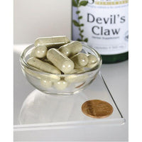 Miniatura de Swanson's Devil's Claw - 500 mg 100 cápsulas numa taça com uma moeda.