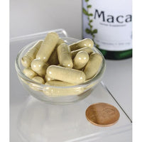 Miniatura de Swanson Maca - 500 mg 100 capsules numa tigela ao lado de um frasco de Swanson Maca.