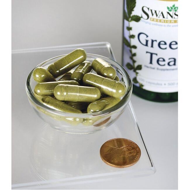 Um frasco de Swanson Green Tea - 500 mg 100 capsules com um cêntimo ao lado.