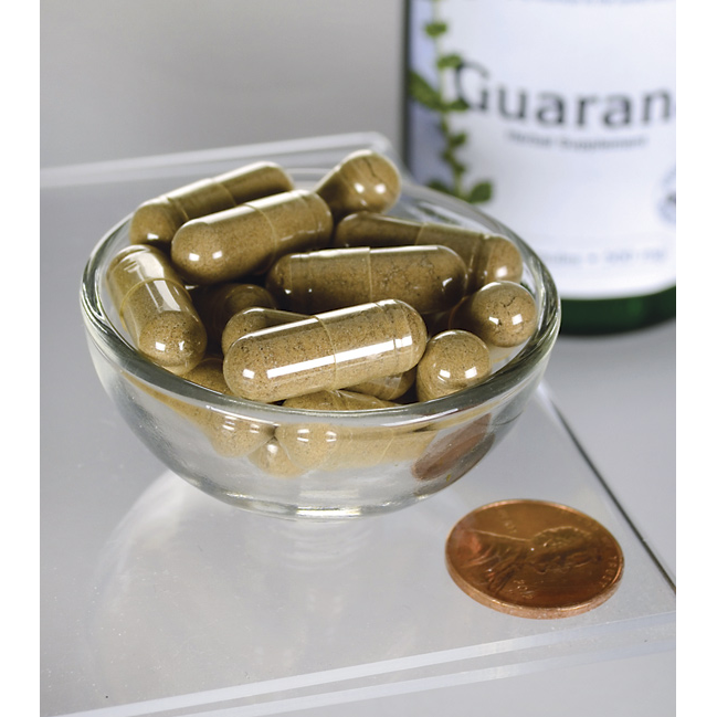 Swanson Guaraná - 500 mg 100 cápsulas numa taça ao lado de uma garrafa.