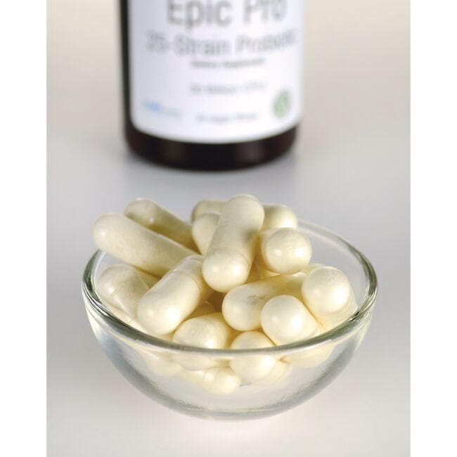 Uma taça de comprimidos brancos ao lado de um frasco de Swanson's Epic Pro 25-Strain Probiotic - 30 vege capsules.