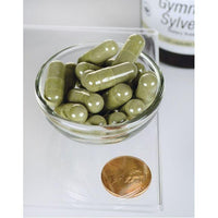 Miniatura de Uma taça de Swanson Gymnema Sylvestre Extract - 300 mg 120 capsules ao lado de uma moeda.