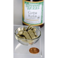 Thumbnail for Um frasco de Swanson Gotu Kola Extract - 100 mg 120 capsules está ao lado de uma tigela.