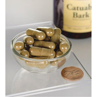 Miniatura de Swanson Catuaba Bark - 465 mg 120 capsules numa tigela ao lado de um frasco.