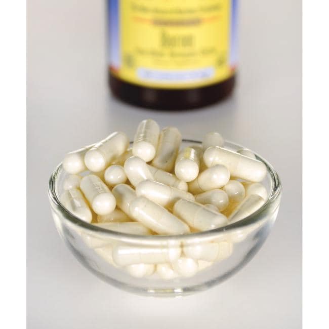 Swanson Albion Boron Bororganic Glycine - 6 mg 60 cápsulas numa taça ao lado de um frasco de vitamina c.