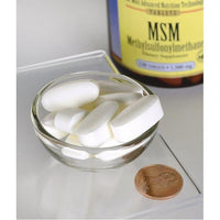 Miniatura de Swanson's MSM - 1,500 mg 120 tabs com propriedades anti-inflamatórias numa tigela ao lado de uma moeda.