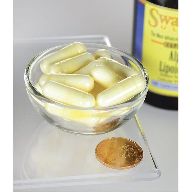 Uma taça de Swanson Alpha Lipoic Acid - 300 mg 60 capsules com uma moeda ao lado.