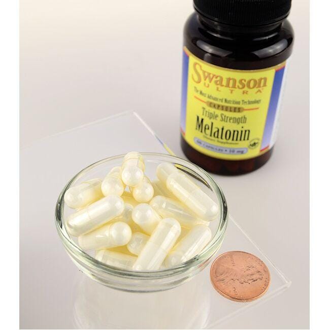 Um frasco de Swanson Melatonin - 10 mg 60 capsules e uma taça de Swanson Melatonin - 10 mg 60 capsules.
