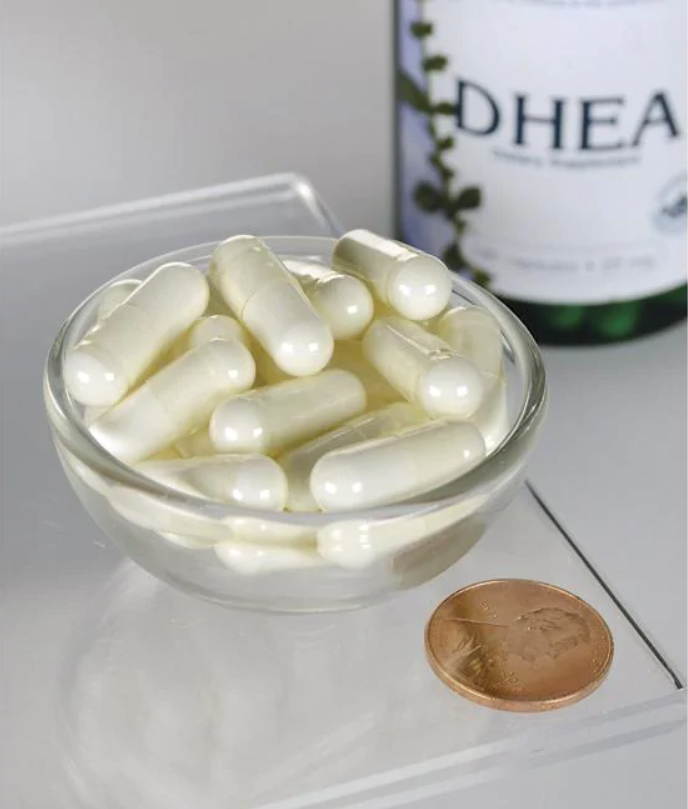 Um frasco de Swanson DHEA - High Potency - 25 mg 120 cápsulas numa taça ao lado de uma moeda.