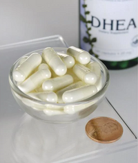 Miniatura de Um frasco de Swanson DHEA - High Potency - 25 mg 120 cápsulas numa taça ao lado de uma moeda.