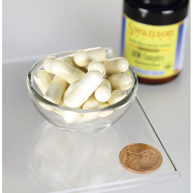 Uma taça de Swanson DIM Complex - 100 mg 30 capsules ao lado de um cêntimo.